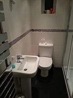 Totally renovated shower room, new double chrome sliding shower door, close coupled w/c, and square basin and tap, also new white 8x6 off-white ceramic wall tiles with a black pebble border. (Beacon Hill)